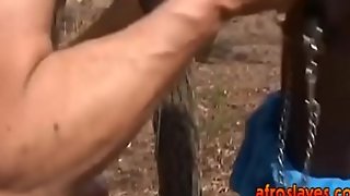 African slave gives master blowjob outdoors